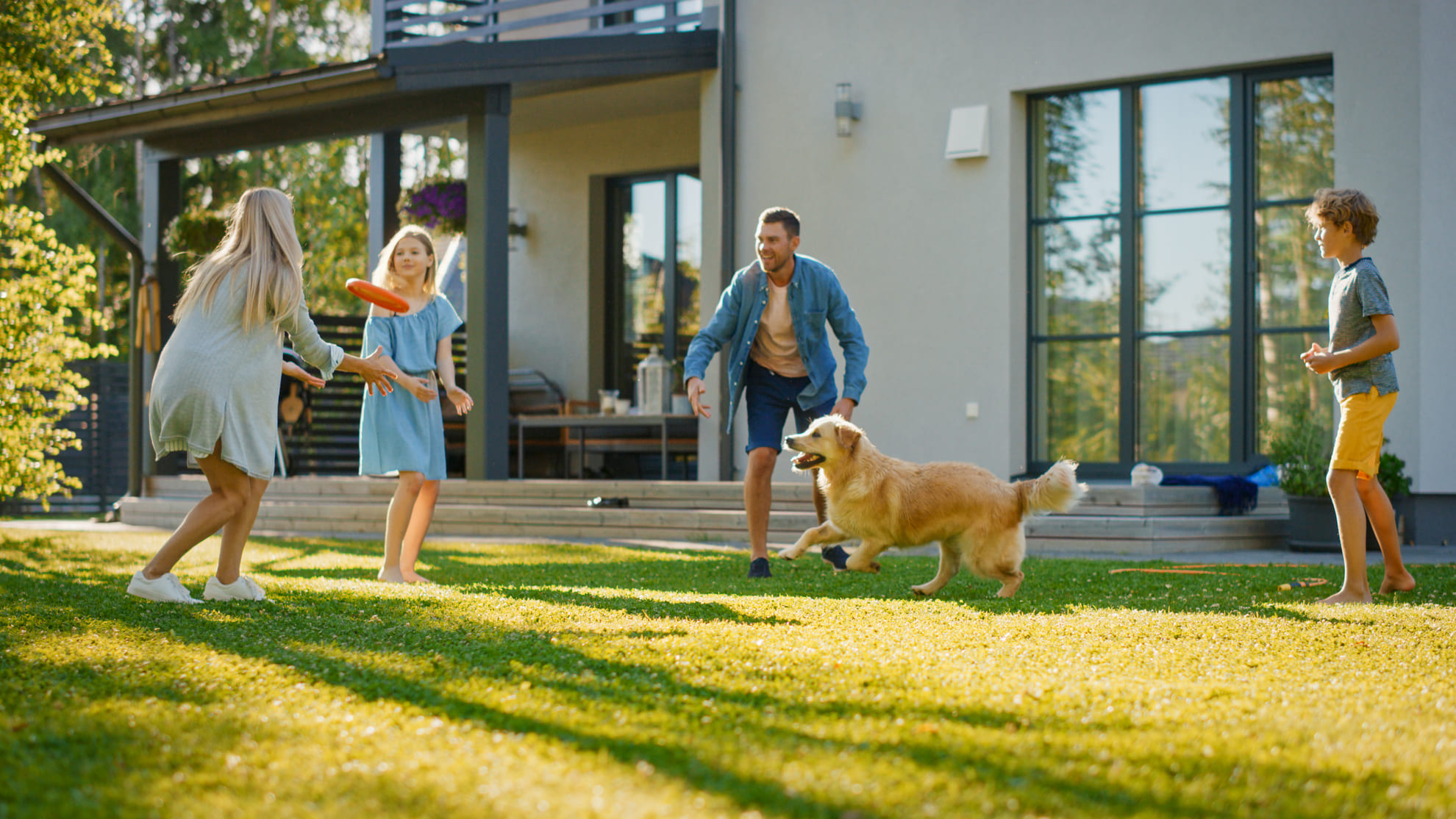 Family play in the garden of their house